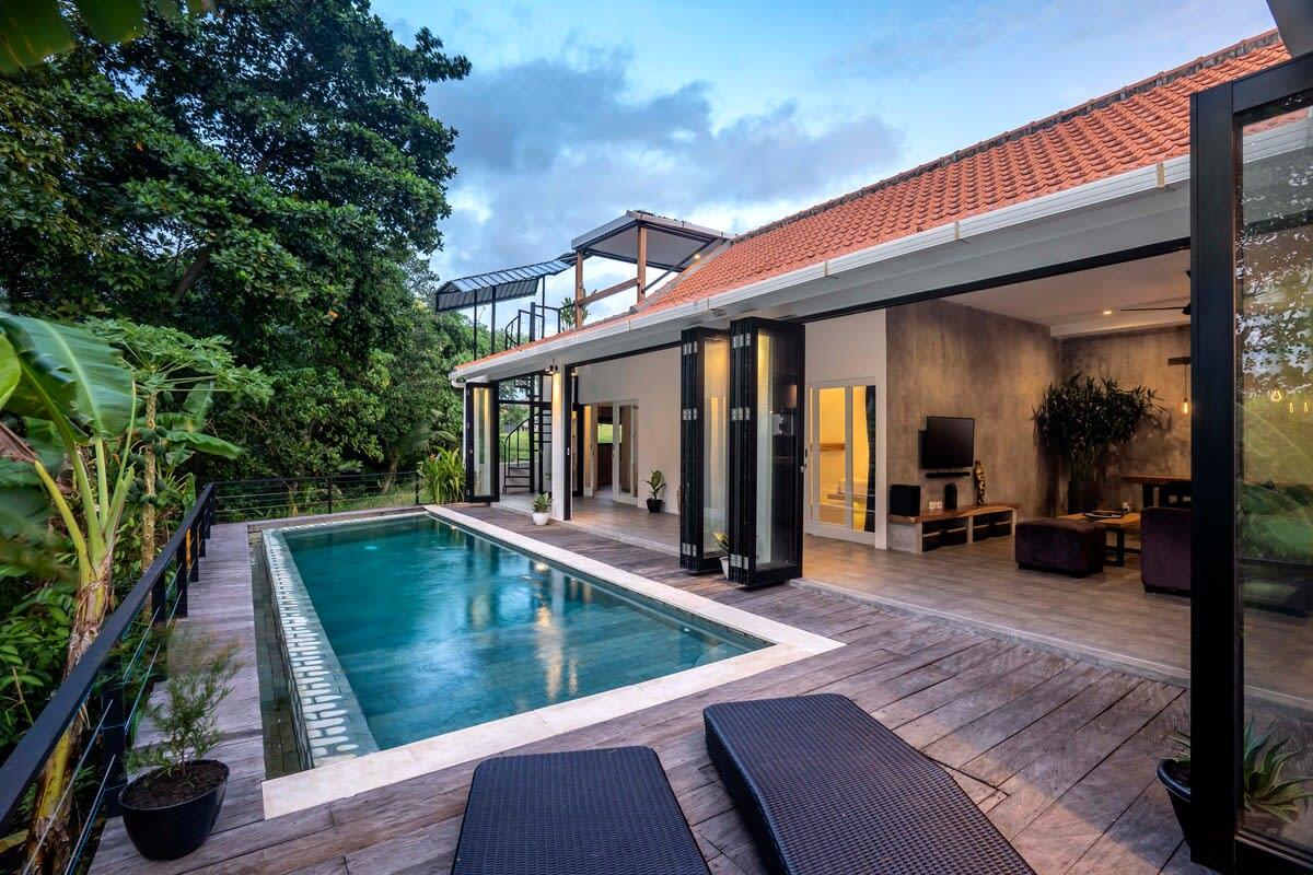 View of the villa and pool from the outside lounging area 