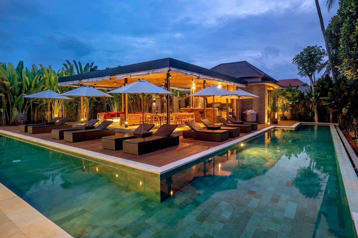 View of the villa’s front and pool at nighttime