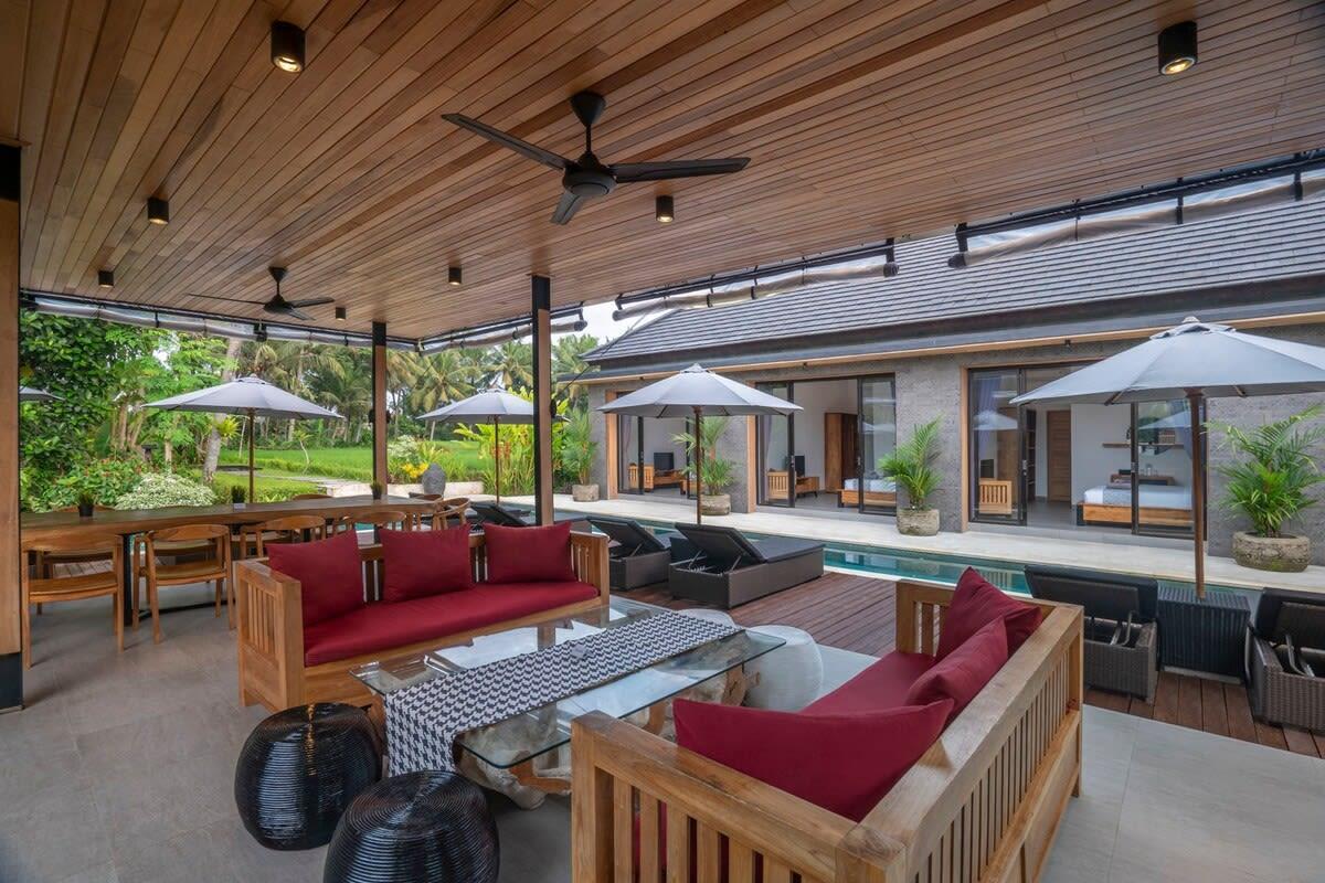 Living & dining room with open space view to pool & rice field