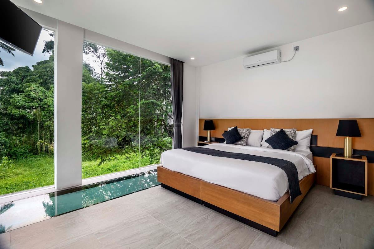 Spacious bedroom with jungle view and pool view from underneath