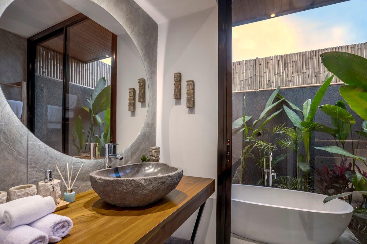 Illuminated bathroom with outside bathtub 