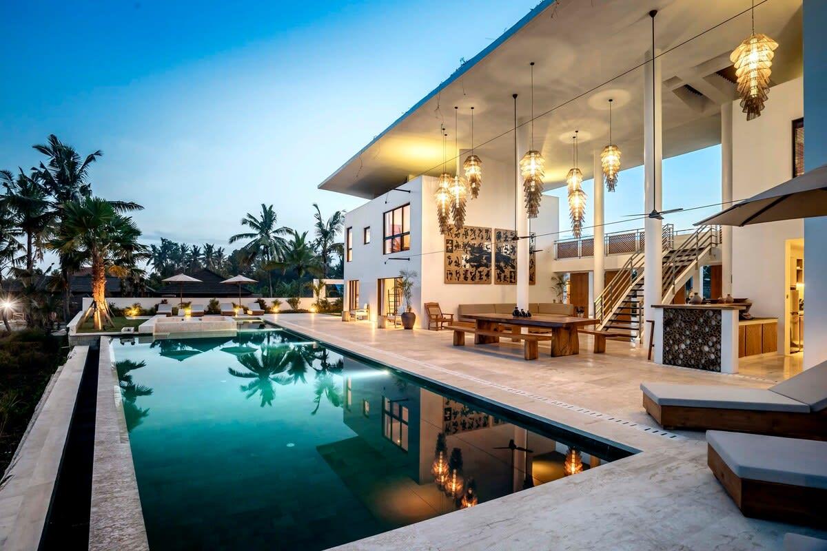 View of the villa’s pool illuminated at night 