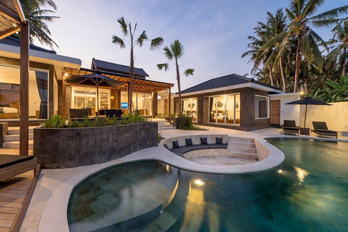 View of the villa’s front and pool at nighttime