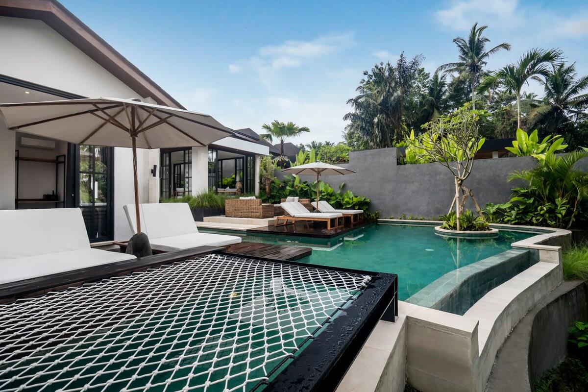 Outdoor hammock on top of the turquoise-colored pool