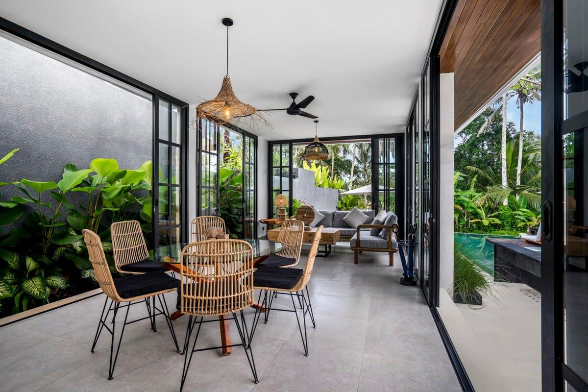 Inside dining area with sliding door leading to the outdoor space 