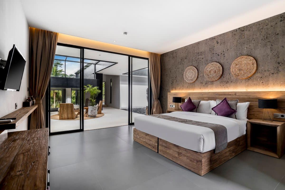 Wooden styled bedroom overlooking one of the sitting areas of the house 