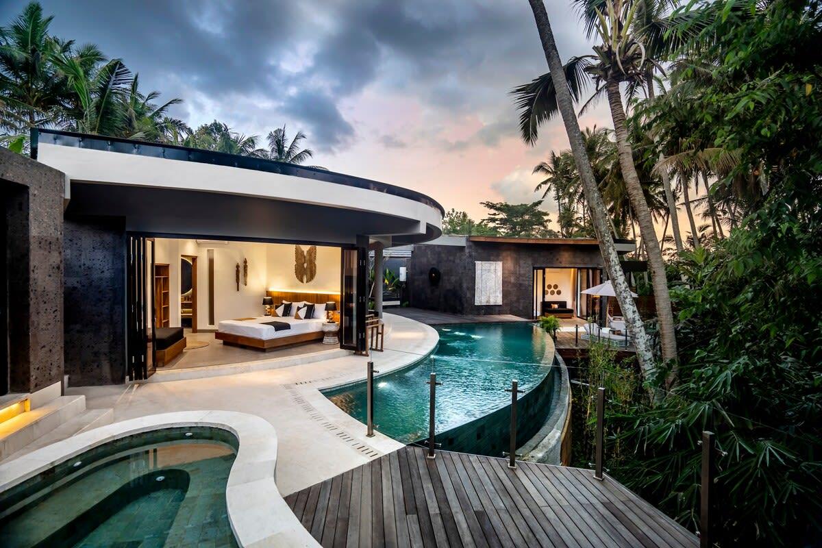 View of an illuminated bedroom from the pool