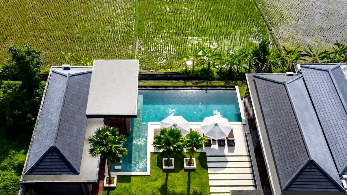 Drone view of the villa and its rice field surroundings 