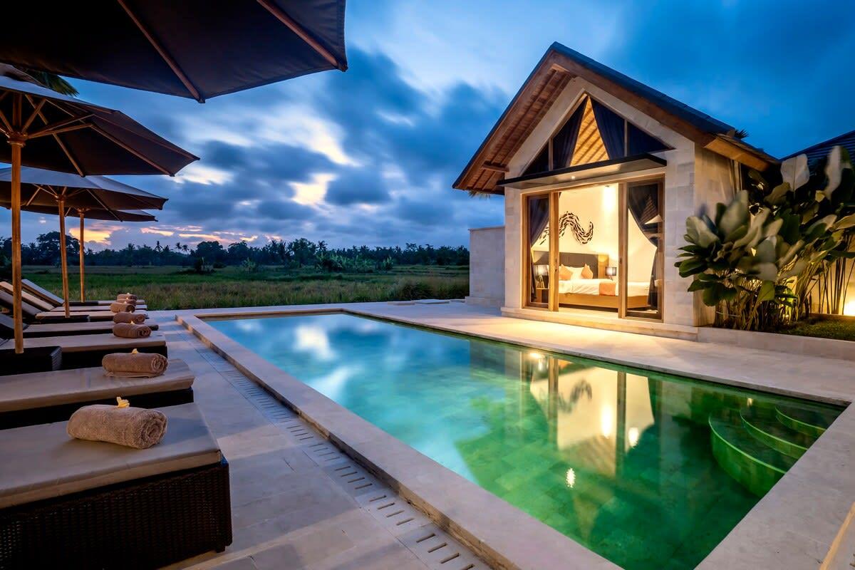 Nighttime view of the pool overlooking the rice fields