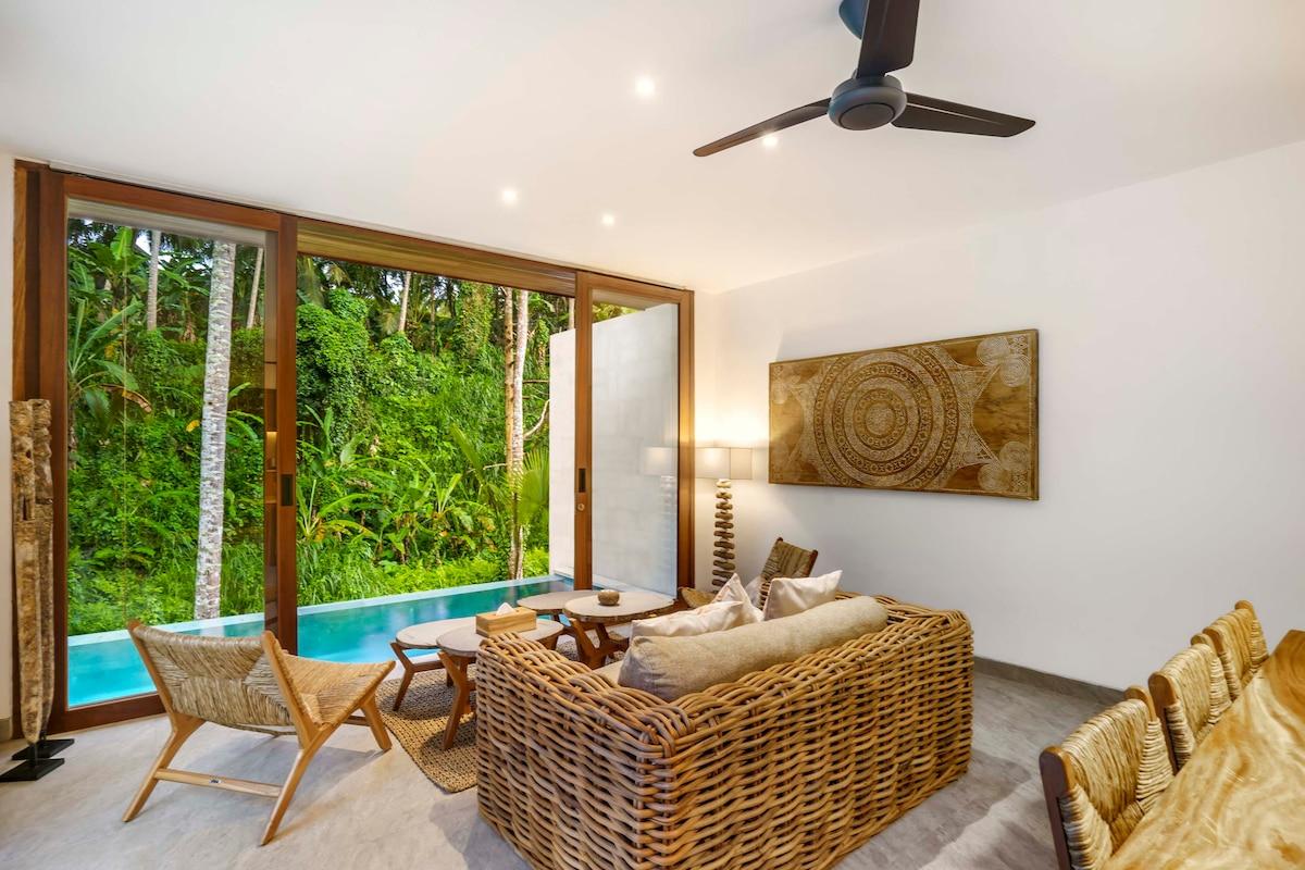 Inside sitting area overlooking the side pool and the jungle background